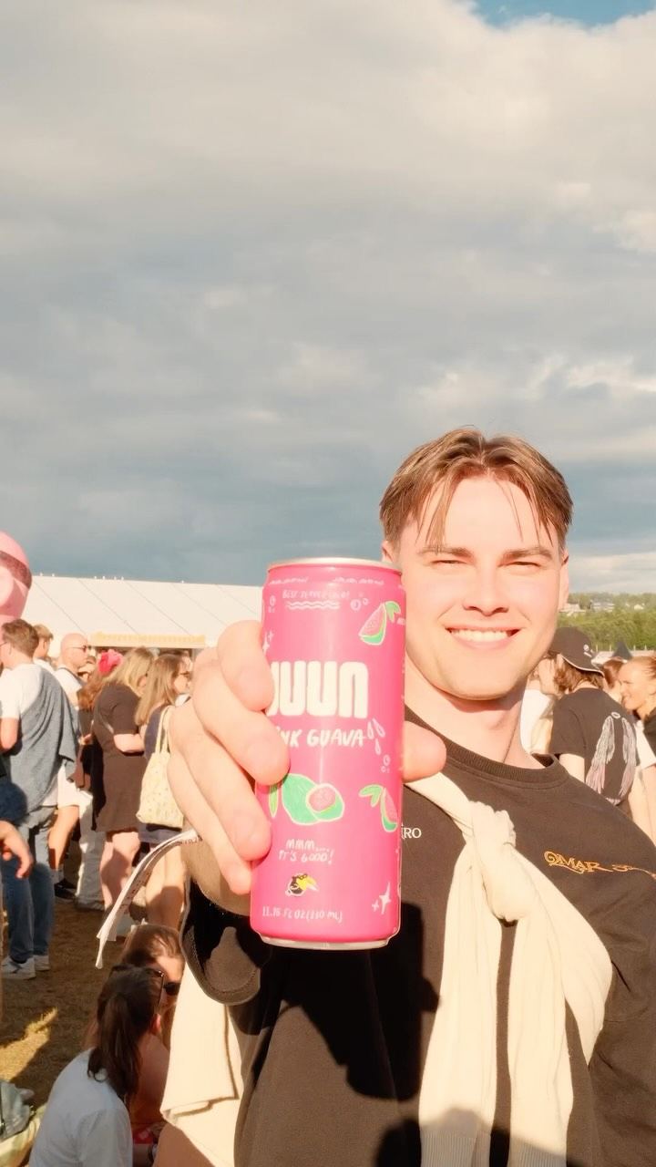 Pink guava JUUN can held up over the crowd